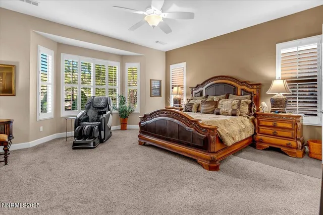 a bedroom with a bed and a large mirror with window