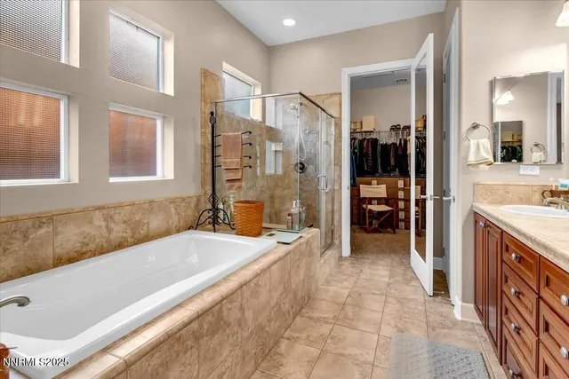 a view of walk in closet with clothes and shoes