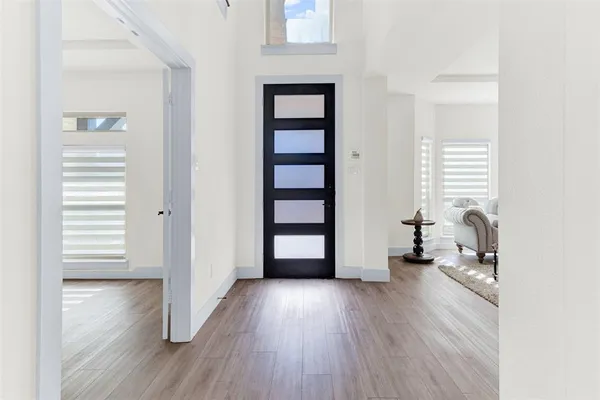 an empty room with wooden floor and closet