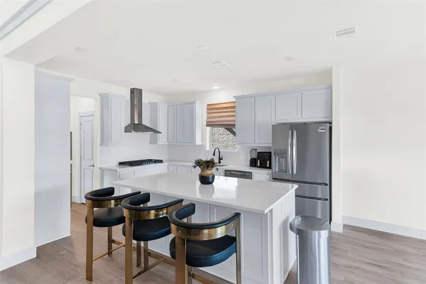 a kitchen with stainless steel appliances a stove a refrigerator and a refrigerator