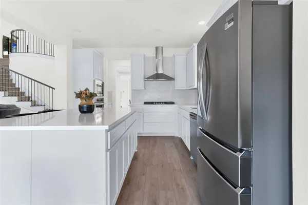 a view of kitchen and hall with wooden floor