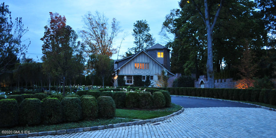 460 North Street Greenwich, CT 06830 - Photo 12 of 25 a front view of a house with a yard and green space