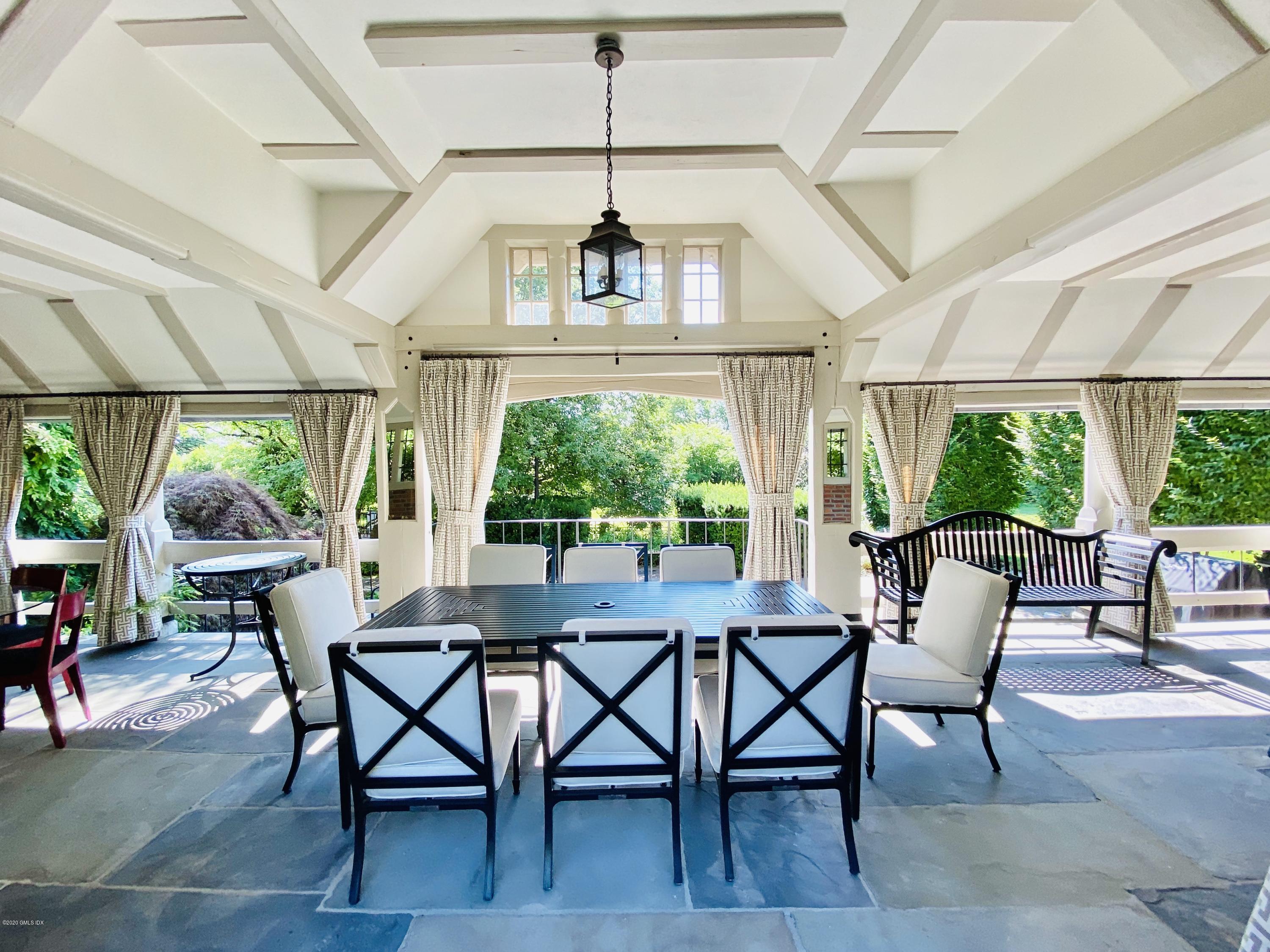 460 North Street Greenwich, CT 06830 - Photo 13 of 25 a dining room with furniture a chandelier and wooden floor
