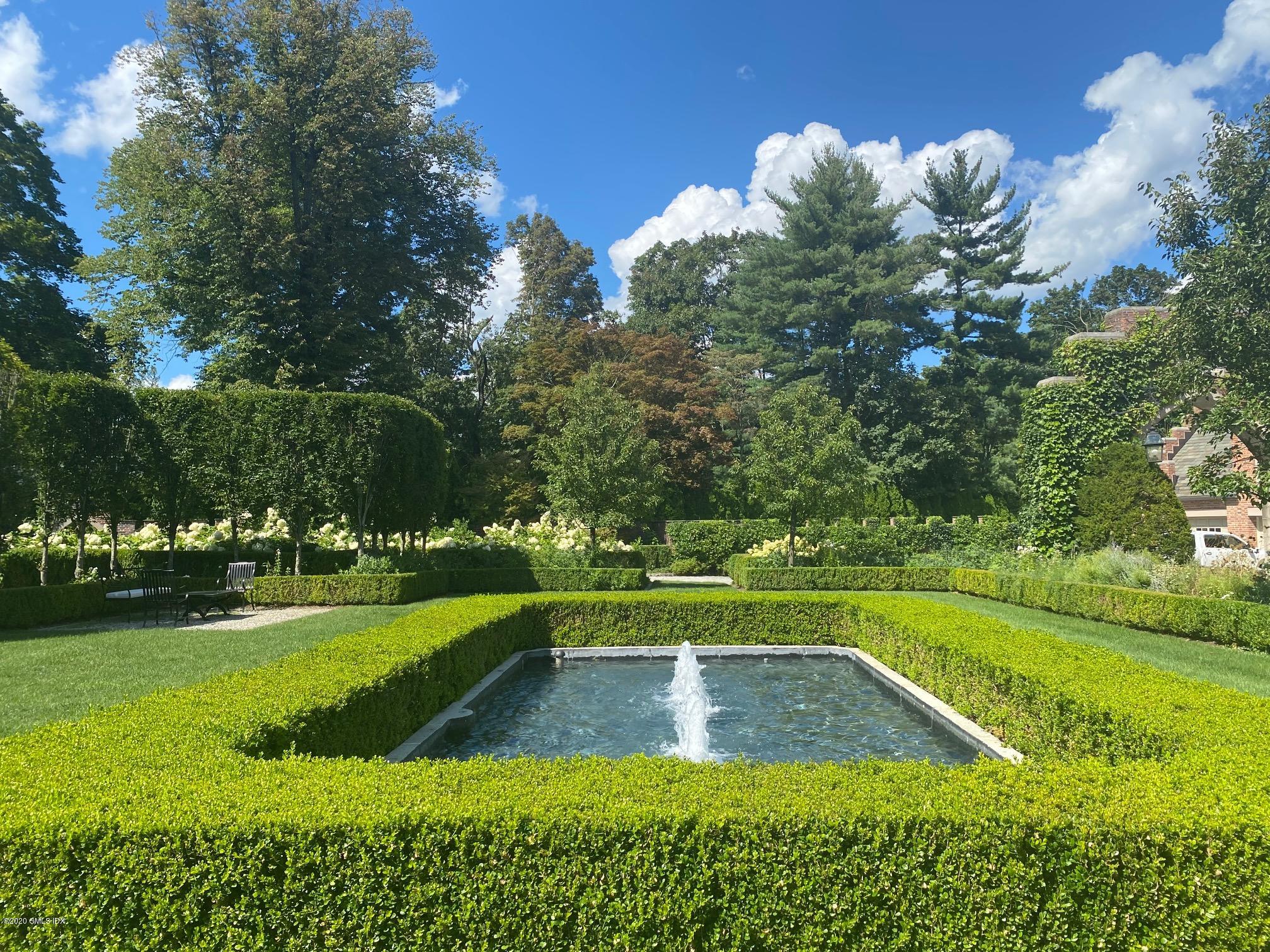 460 North Street Greenwich, CT 06830 - Photo 16 of 25 a view of a swimming pool with a garden