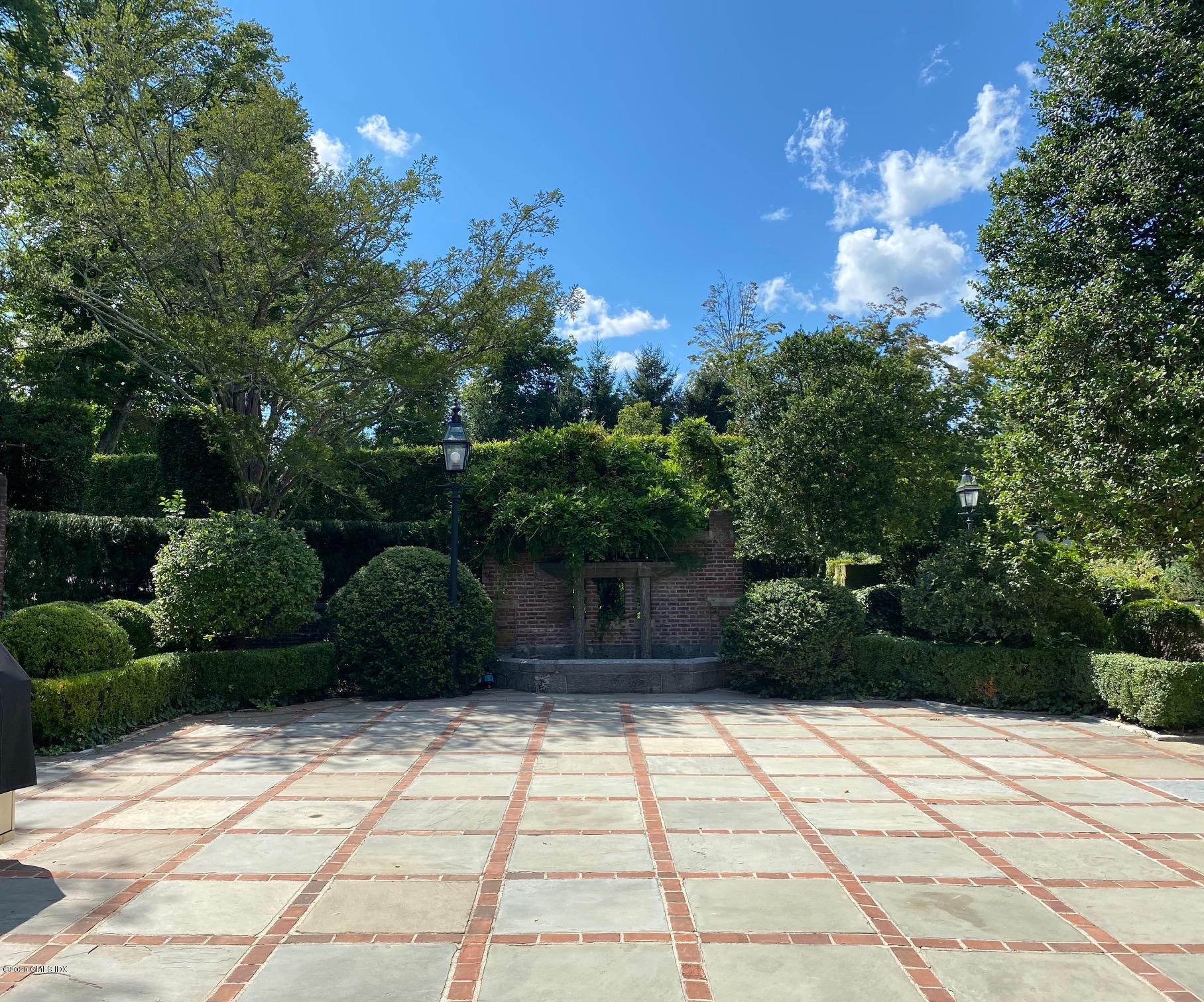 460 North Street Greenwich, CT 06830 - Photo 23 of 25 a view of backyard with potted plants and large trees