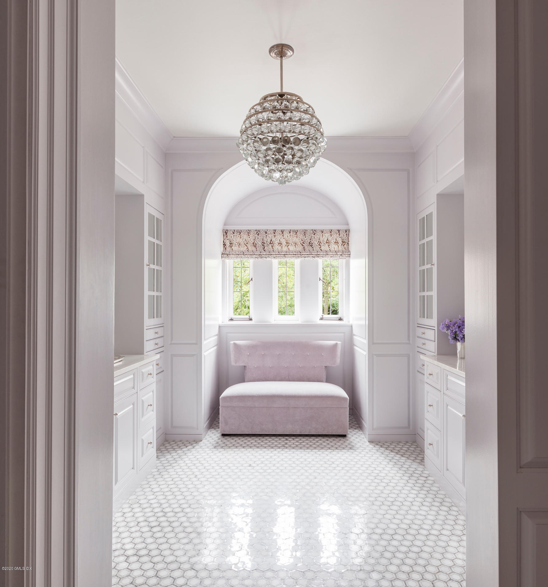 460 North Street Greenwich, CT 06830 - Photo 7 of 25 a bedroom with a bed and a chandelier