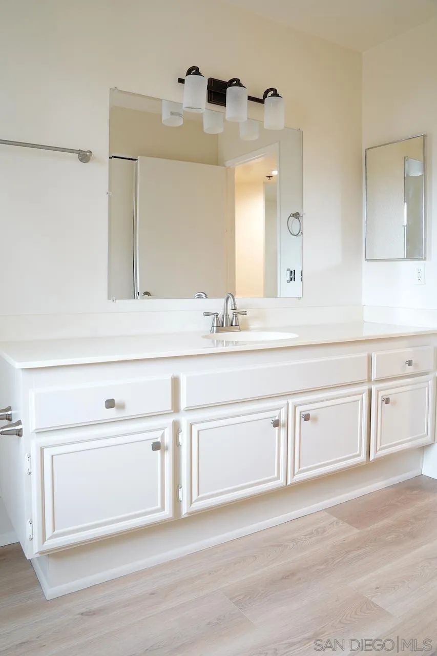 17161 Alva Road, Unit 3125 San Diego, CA 92127 - Photo 17 of 29 a bathroom with a sink vanity and mirror