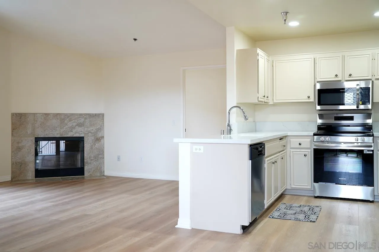 17161 Alva Road, Unit 3125 San Diego, CA 92127 - Photo 3 of 29 a kitchen with stainless steel appliances a stove a sink and a microwave