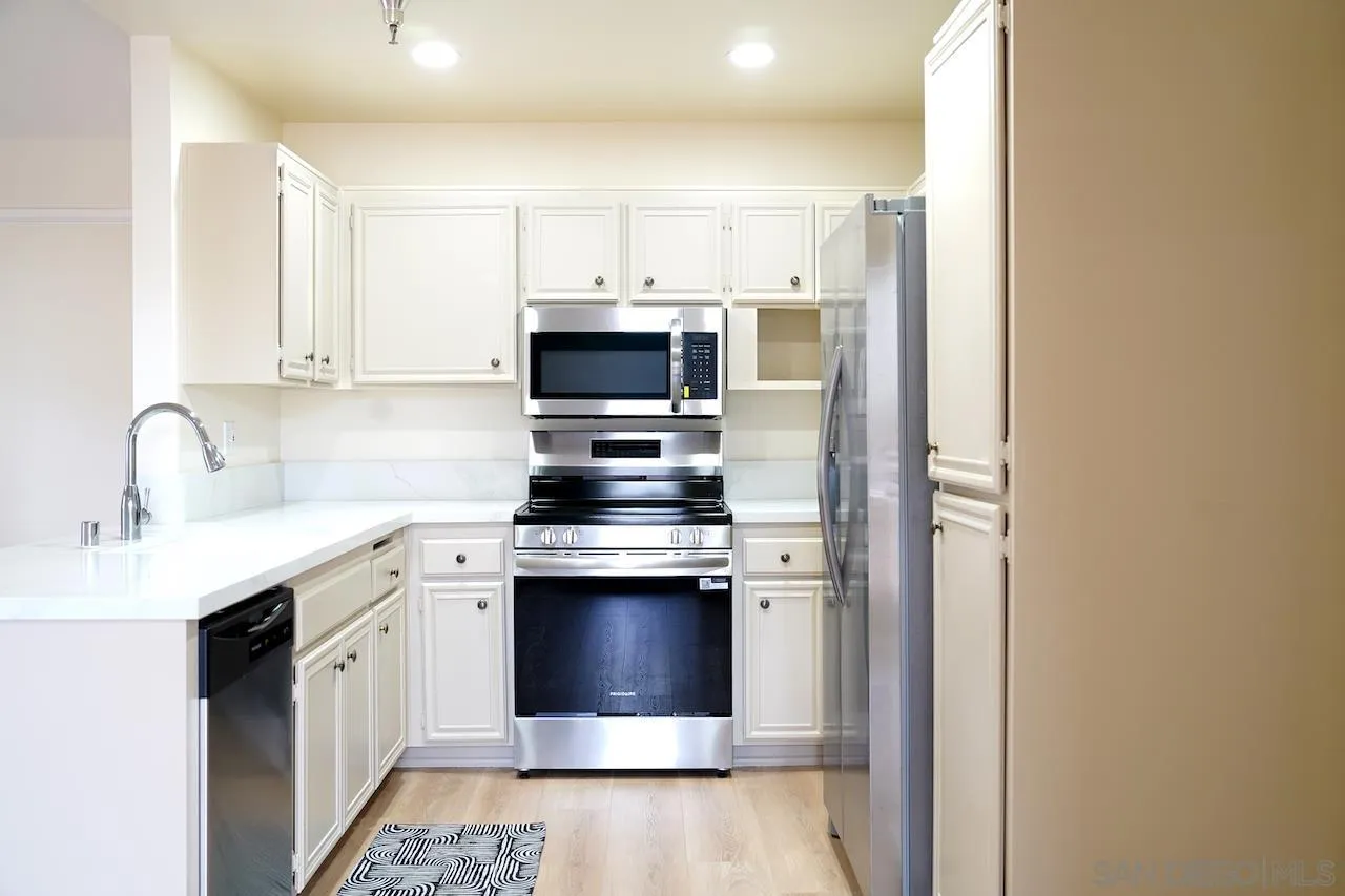17161 Alva Road, Unit 3125 San Diego, CA 92127 - Photo 4 of 29 a kitchen with stainless steel appliances a sink stove and refrigerator