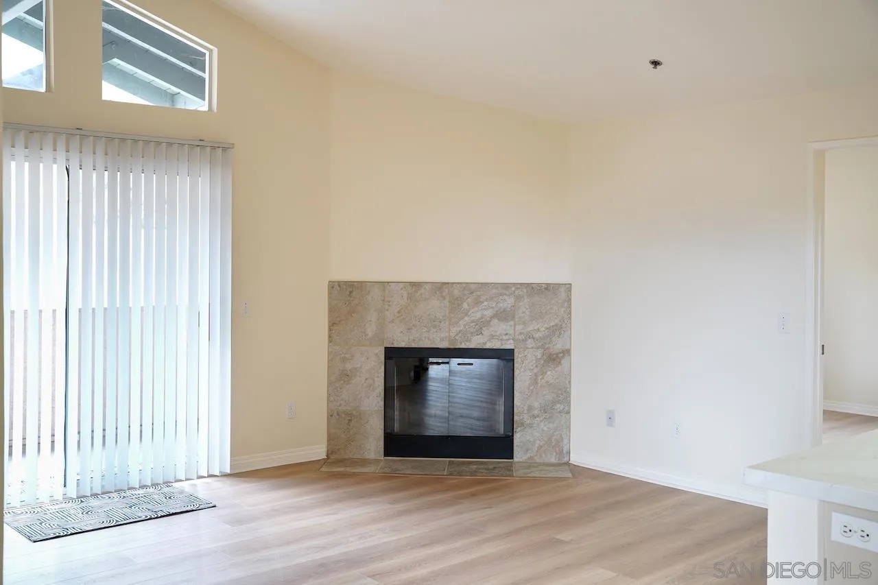 17161 Alva Road, Unit 3125 San Diego, CA 92127 - Photo 6 of 29 an empty room with wooden floor fireplace and windows