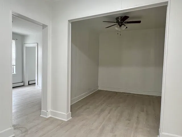 a view of a room with wooden floor
