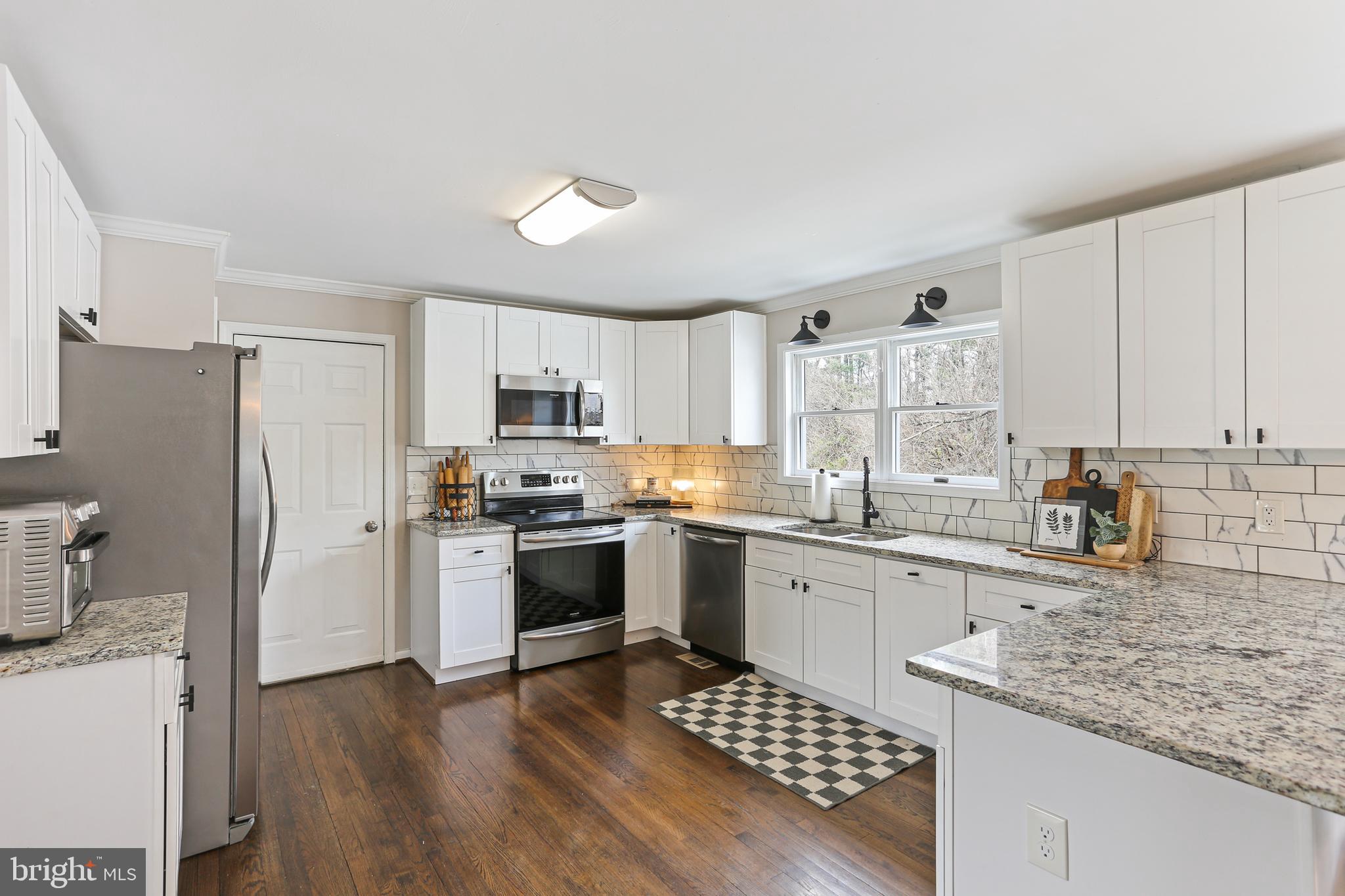3234 Bidle Road Middletown, MD 21769 - Photo 12 of 45 a kitchen with granite countertop a refrigerator stove top oven and sink