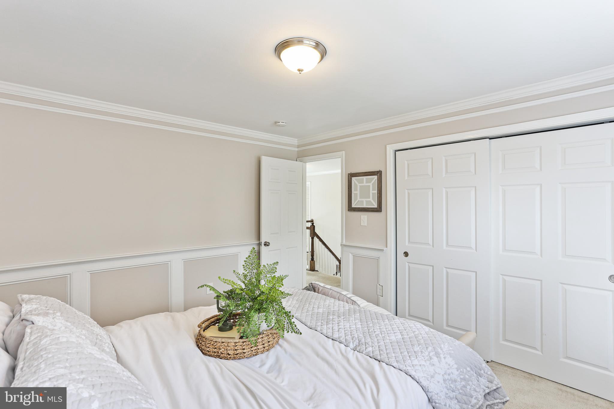 3234 Bidle Road Middletown, MD 21769 - Photo 28 of 45 a bedroom with a bed and a potted plant