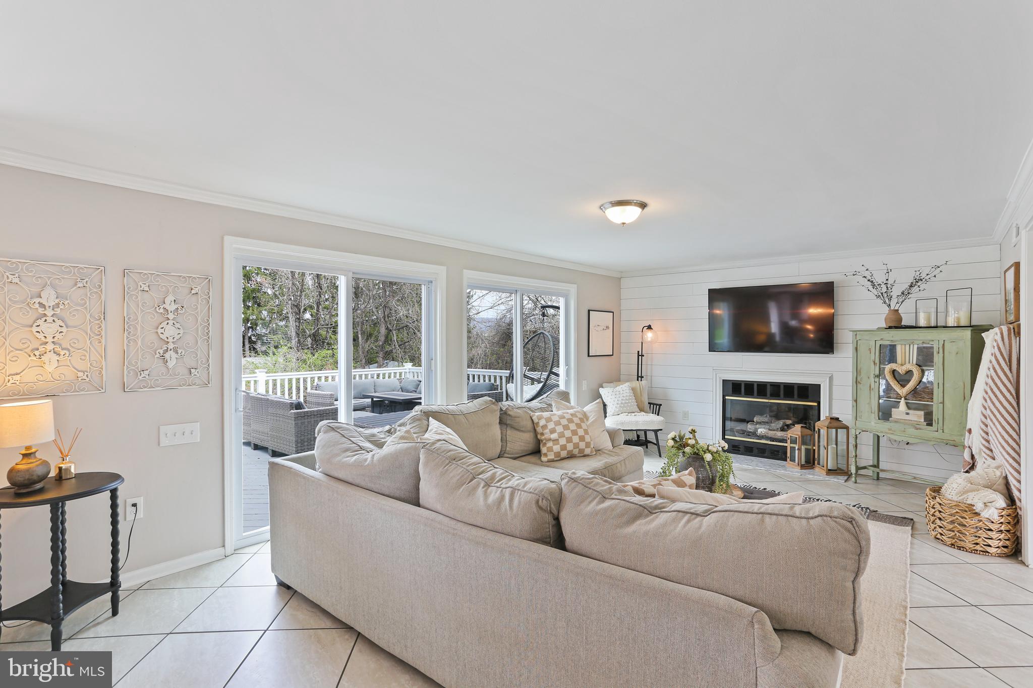 3234 Bidle Road Middletown, MD 21769 - Photo 7 of 45 a living room with fireplace furniture and a flat screen tv