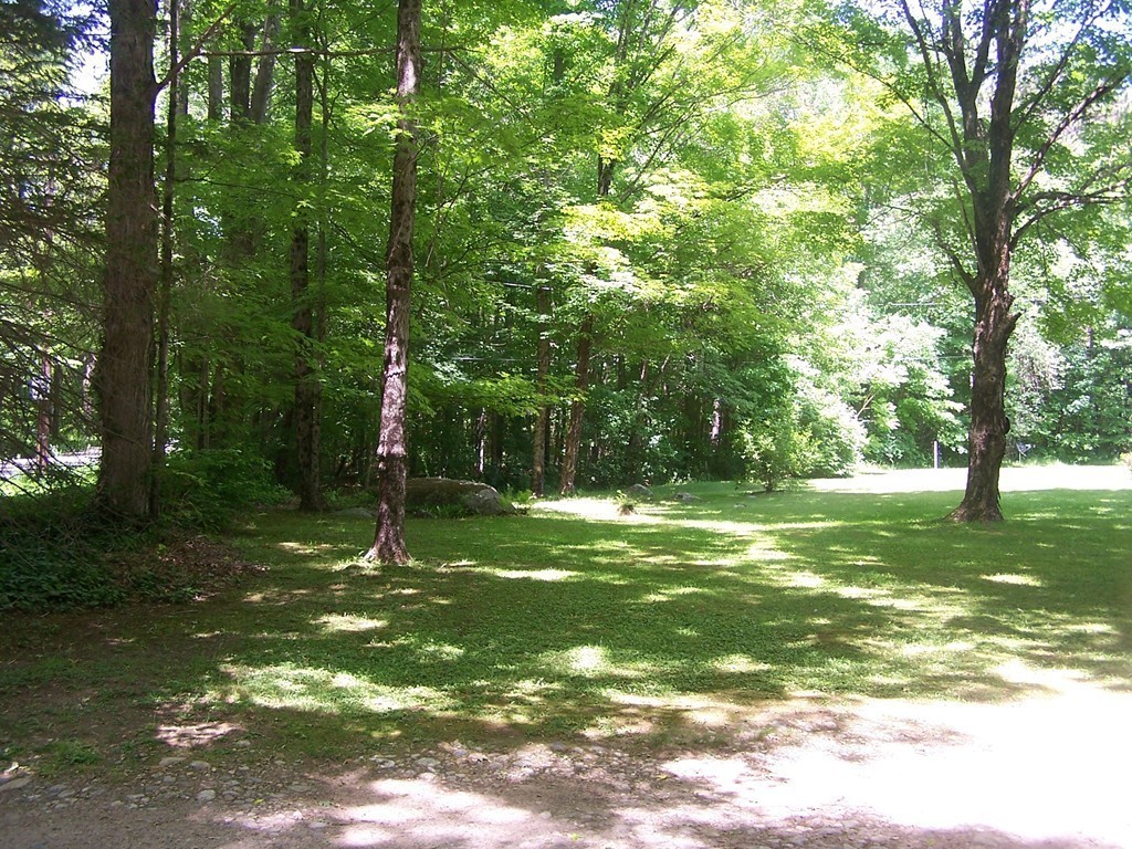 147 Hardwick Road Petersham, MA 01366 - Photo 12 of 13 a backyard of a house with lots of green space
