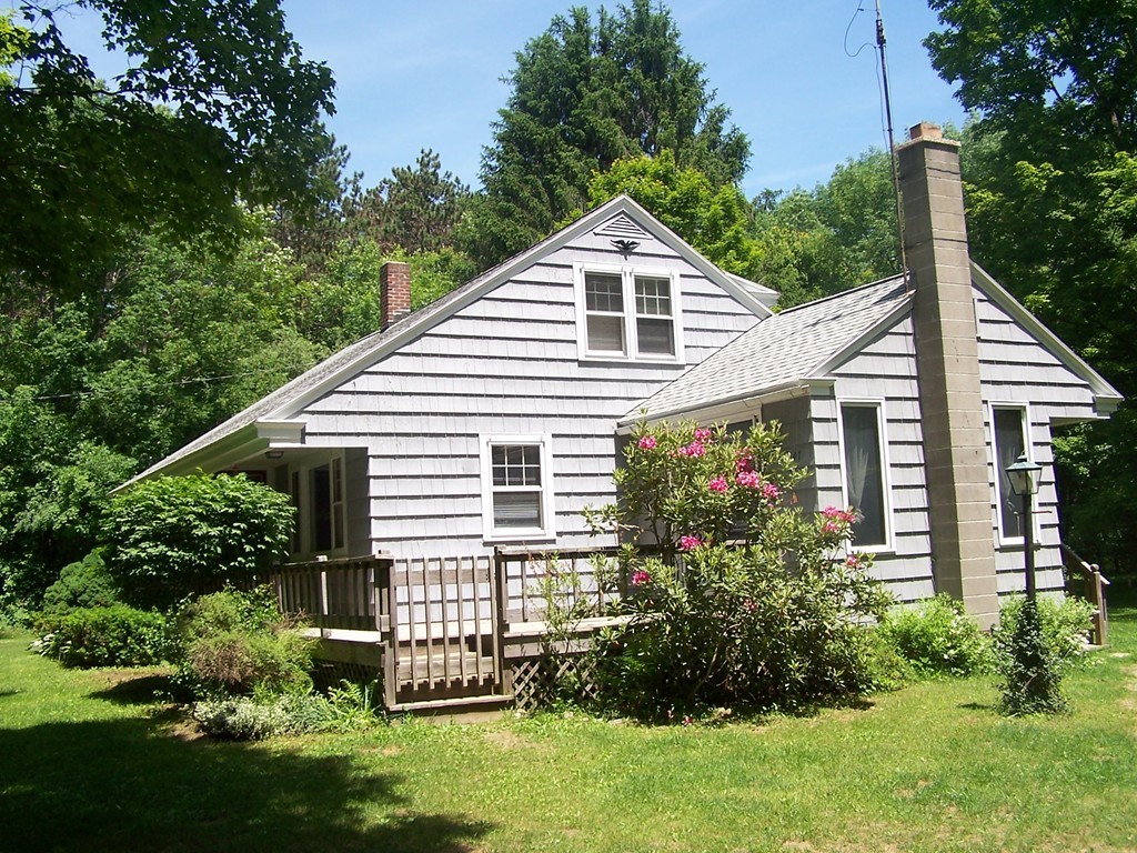 147 Hardwick Road Petersham, MA 01366 - Photo 3 of 13 a view of a house with brick walls and a yard with plants