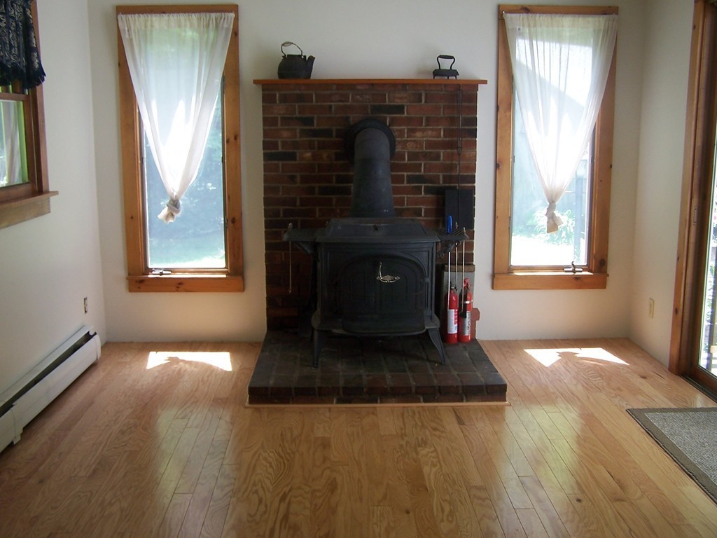 147 Hardwick Road Petersham, MA 01366 - Photo 8 of 13 a living room with furniture and a fireplace