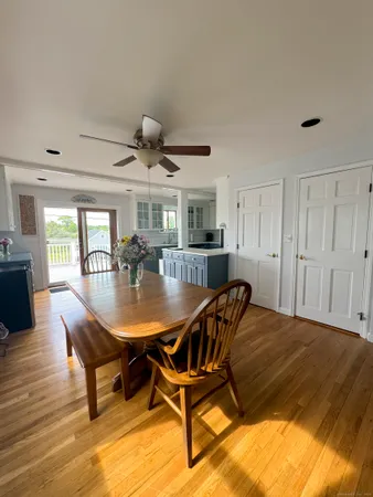a living room with dining table and wooden floor