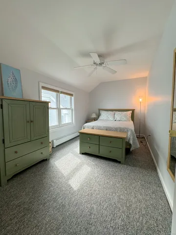 a room with a bed and a dresser