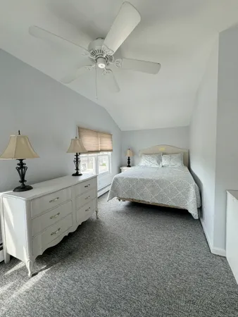 a room with a bed and a dresser