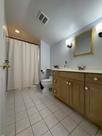 a spacious bathroom with a double vanity sink and mirror