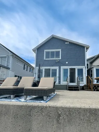 a front view of house with yard and car parked