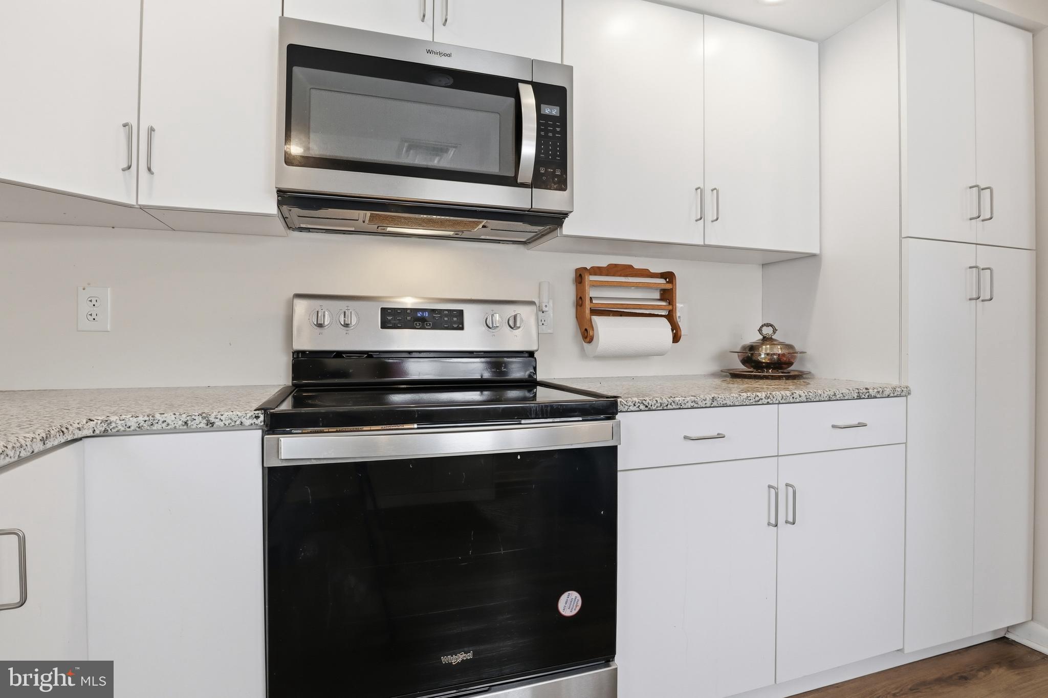 521 South Findlay Street York, PA 17402 - Photo 12 of 45 a kitchen with stainless steel appliances granite countertop white cabinets and a stove top oven