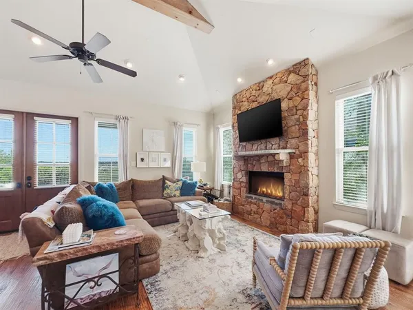 a living room with furniture a fireplace and a flat screen tv