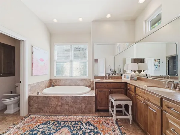 a large bathroom with a large tub sink and toilet