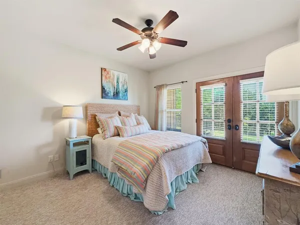 a bedroom with a bed and a large window