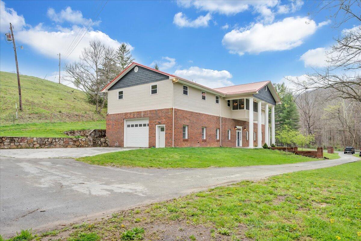 7415 Clear Fork Creek Road Bastian, VA 24314 - Photo 11 of 117 a view of a big house with a big yard and large trees