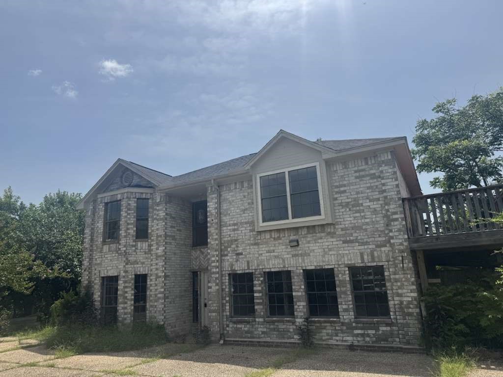 a front view of a house with brick walls