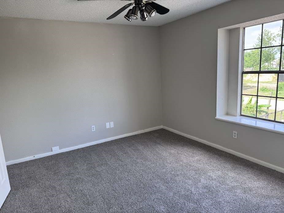 5407 Victoria Drive Rosharon, TX 77583 - Photo 15 of 23 an empty room with a window and a chandelier fan