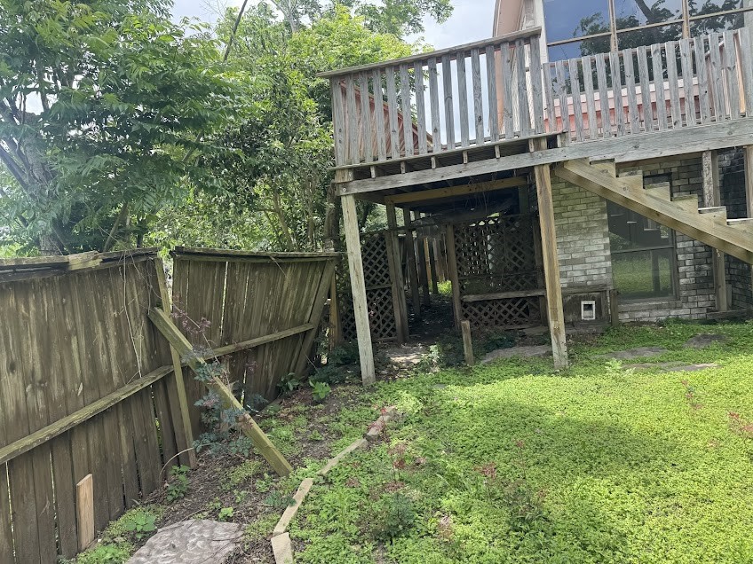5407 Victoria Drive Rosharon, TX 77583 - Photo 20 of 23 a view of a backyard with a small cabin and a wooden deck