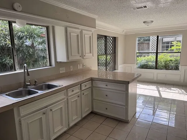 a kitchen with a sink and large window