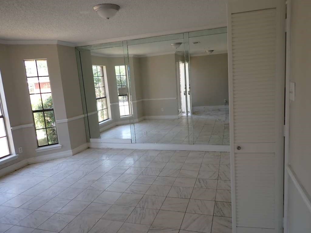 5407 Victoria Drive Rosharon, TX 77583 - Photo 7 of 16 a view of an empty room with a fireplace and a window