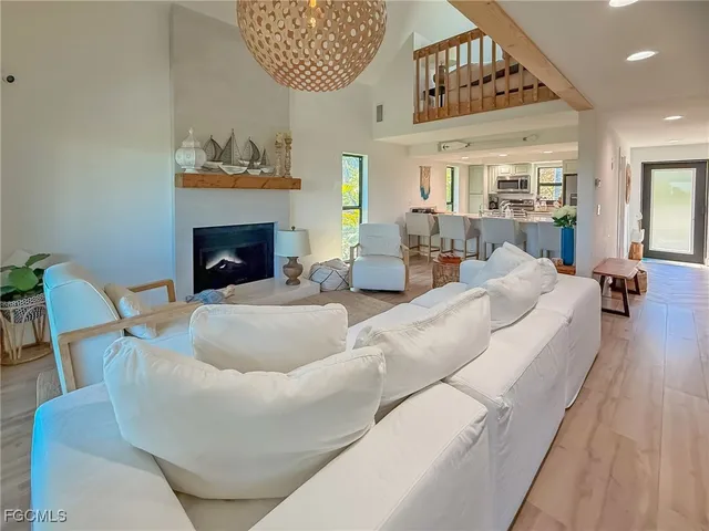 a kitchen with a dining table chairs refrigerator and stove