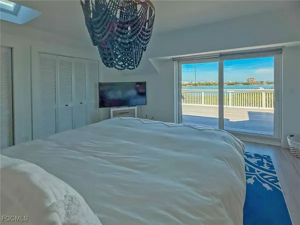 a bedroom with a bed and glass window