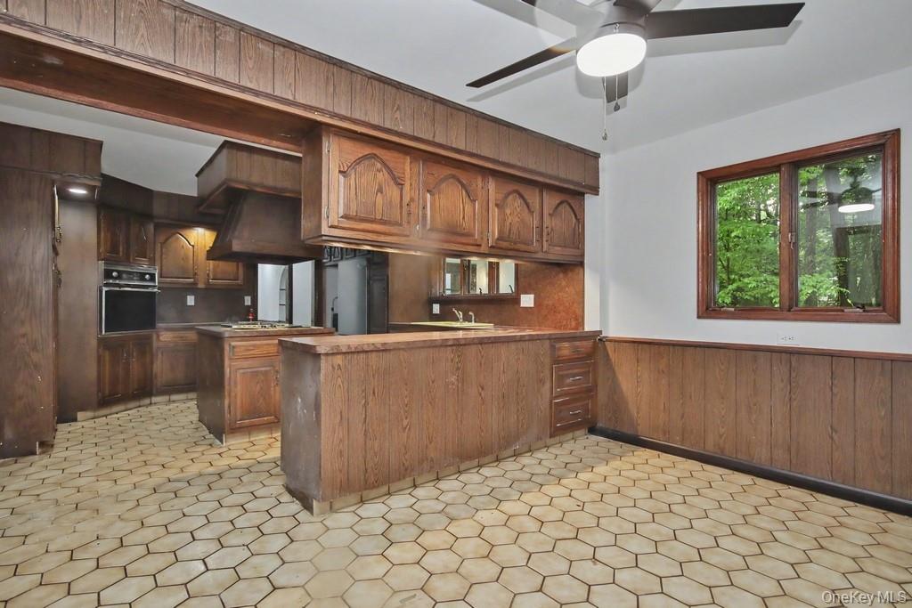 18 Hillside View Road Mahopac, NY 10541 - Photo 23 of 42 a kitchen with a stove a refrigerator and chandelier