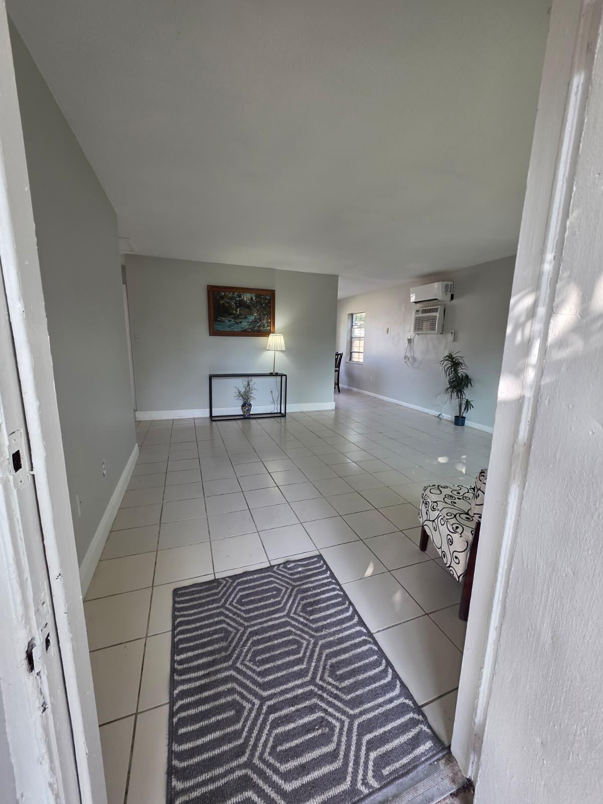 3386 Rudolph Road Lake Worth Beach, FL 33461 - Photo 7 of 25 a view of a living room with furniture and wooden floor