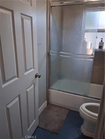 a bathroom with a toilet and a bathtub