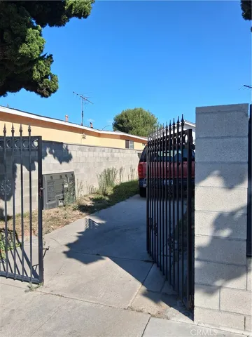 a view of backyard with wooden fence and trees