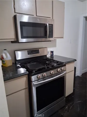 a kitchen with a stove and a microwave