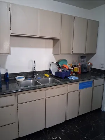 a kitchen with sink and cabinets