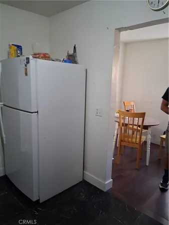 a white refrigerator freezer sitting in a kitchen