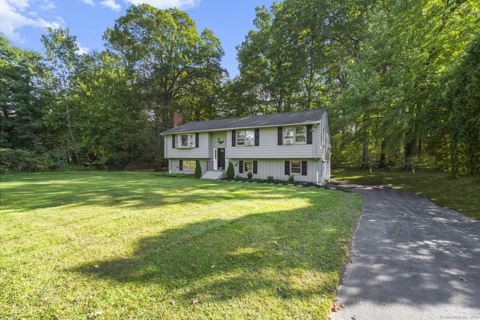 779 Bridge Street Suffield, CT 06078 - Photo 1 of 35 a view of a house with a big yard and large trees