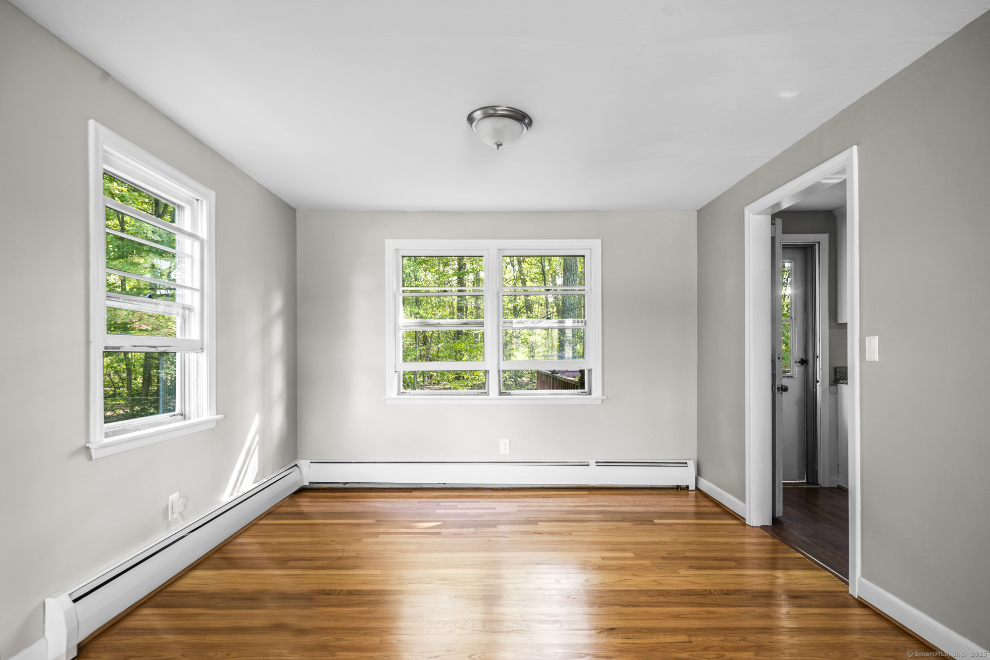 779 Bridge Street Suffield, CT 06078 - Photo 13 of 35 a view of an empty room with wooden floor and a window