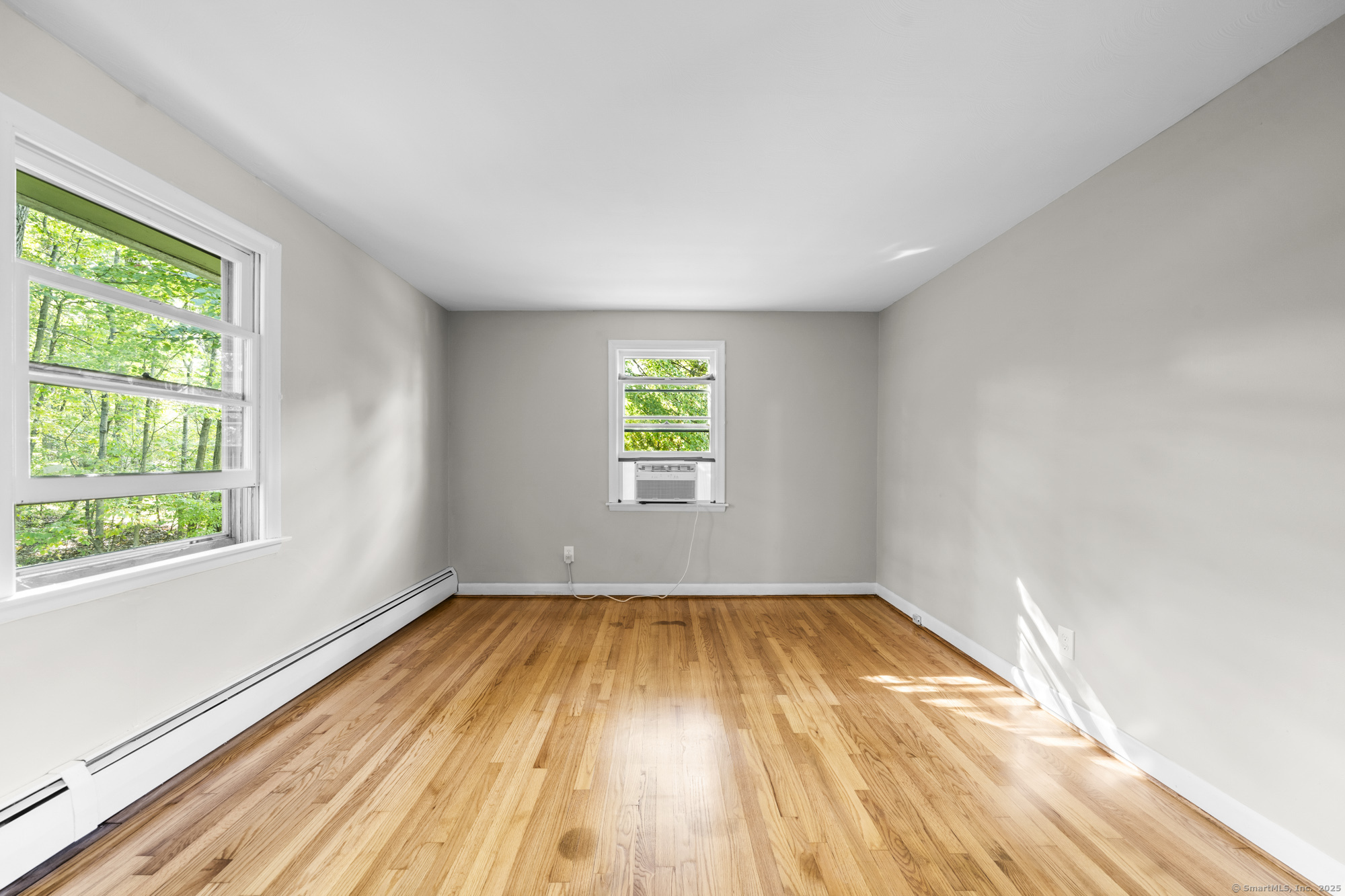 779 Bridge Street Suffield, CT 06078 - Photo 21 of 35 a view of an empty room with wooden floor and a window