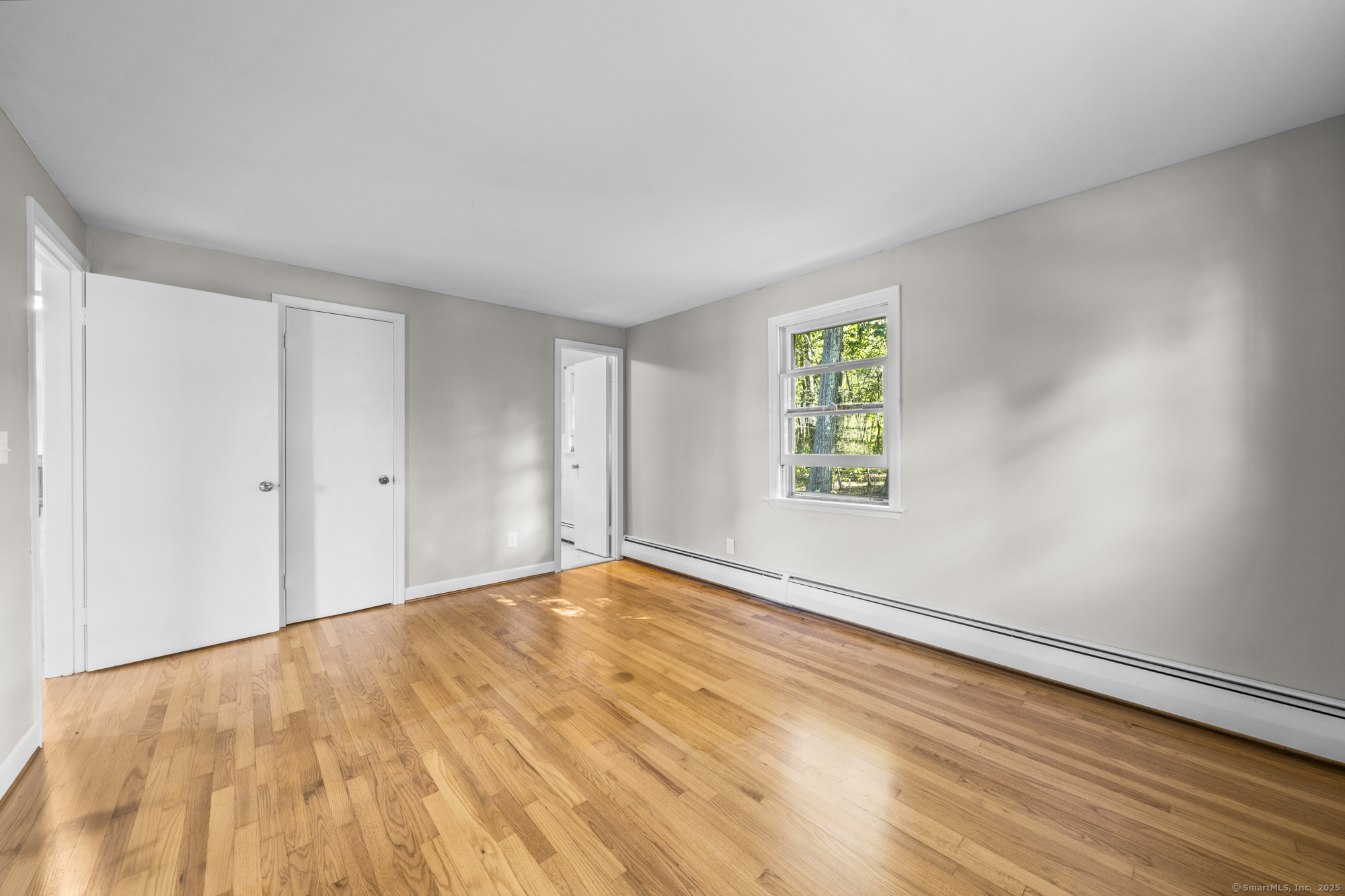 779 Bridge Street Suffield, CT 06078 - Photo 22 of 35 a view of an empty room with window and wooden floor