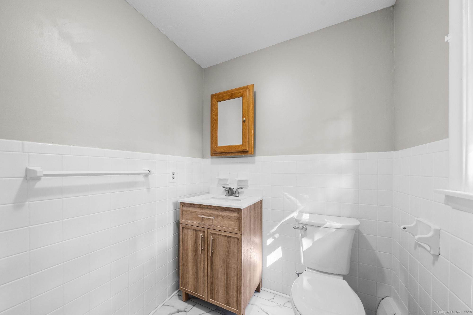 779 Bridge Street Suffield, CT 06078 - Photo 23 of 35 a bathroom with a toilet a sink and mirror
